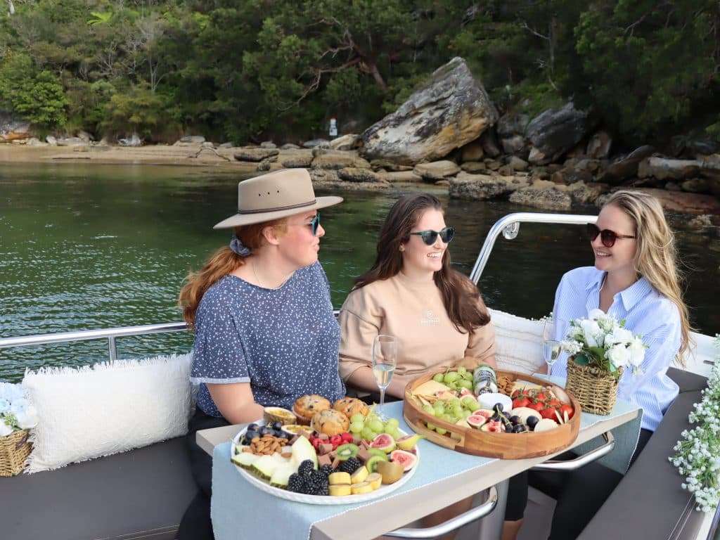 people enjoying picnic on a rented boat for self drive