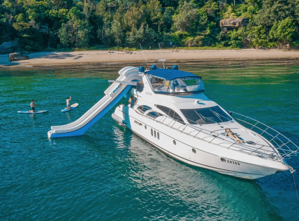 a white boat with a slide on the water