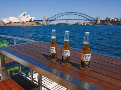 a group of bottles on a table by water