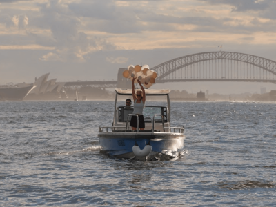 party boat hire in Sydney with baloons in front of opera house