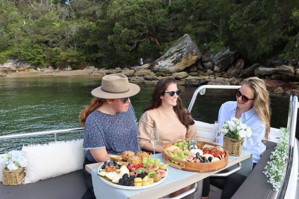 a group of women on a boat eating food