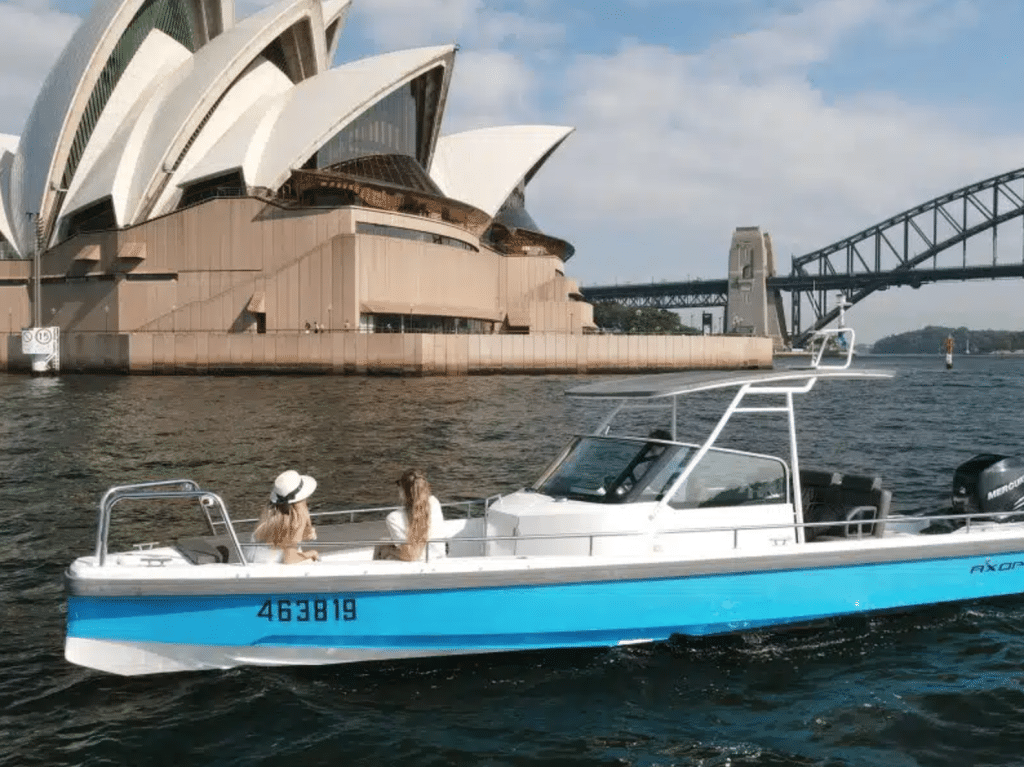 rented boat in front of sydney opera