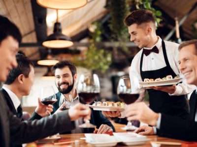 Premium Photo Waiter serves drinks and food for chinese business
