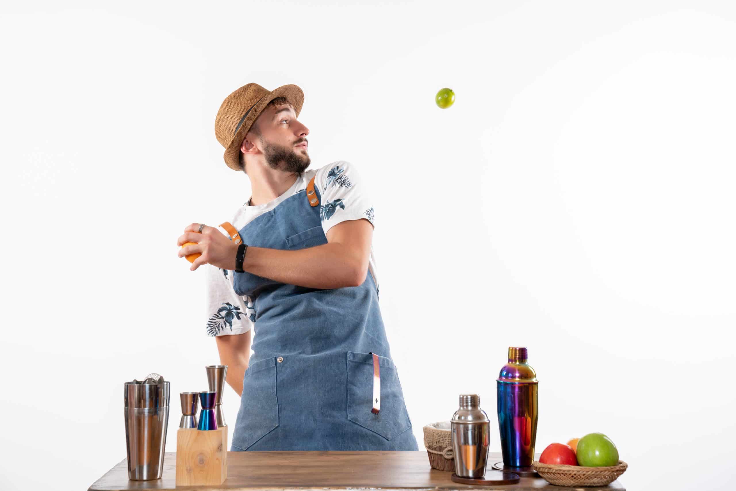 front-view-male-bartender-front-bar-desk-playing-with-fruits-white-wall-bar-alcohol-night-job-fruit-drink-club - Boat Club for Couples Sydney
